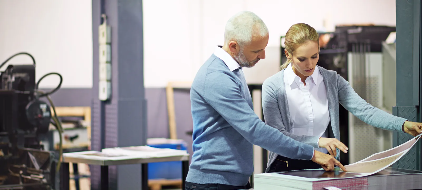 Two print professionals reviewing a production proof