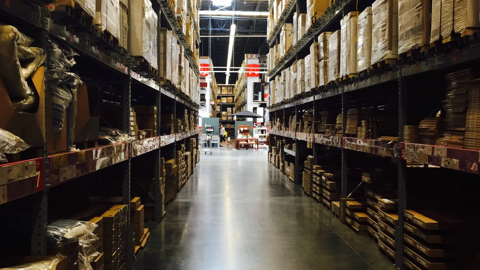 Warehouse aisle stocked with labelled cartons