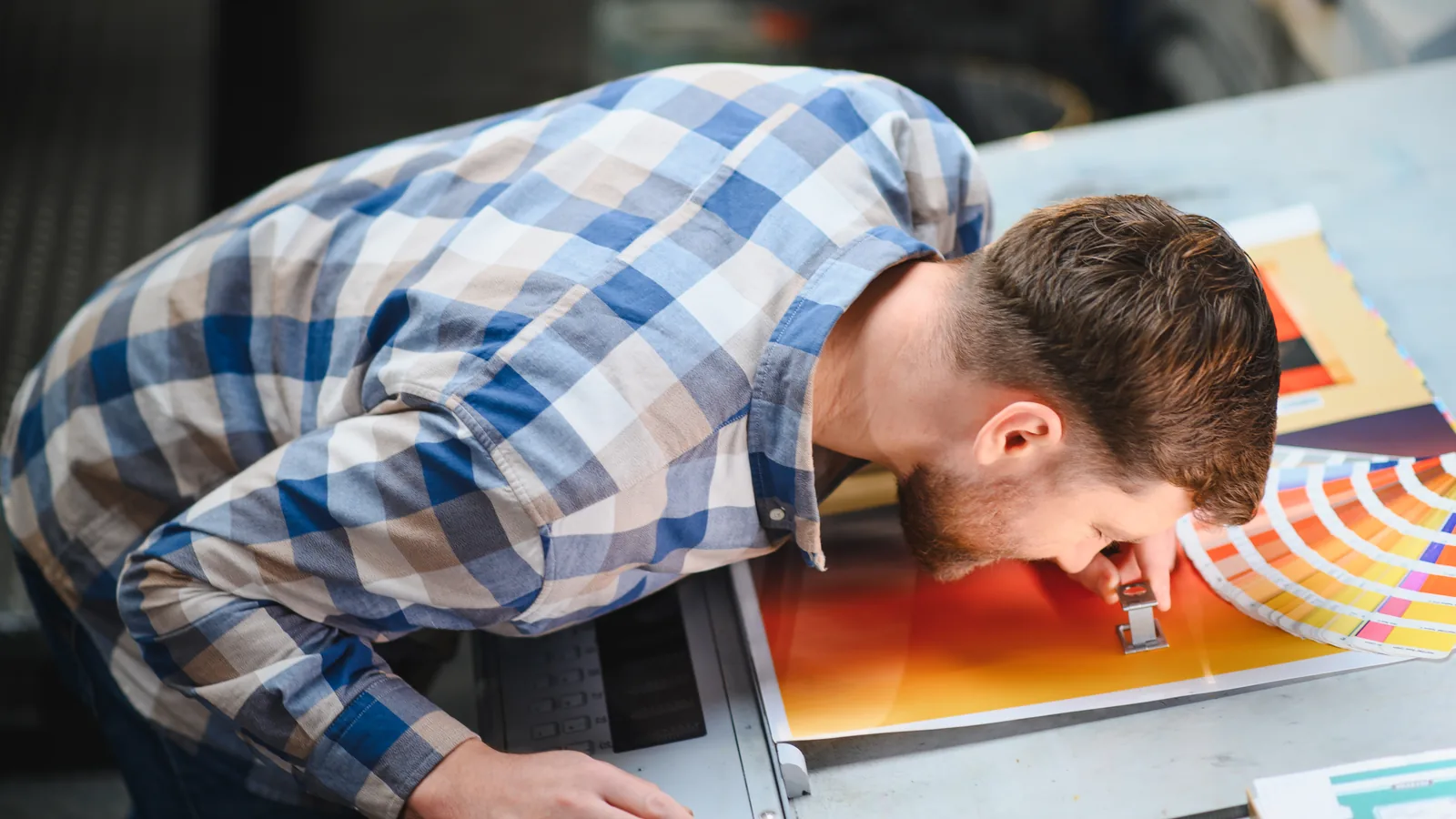 Print specialist checking colour and label quality