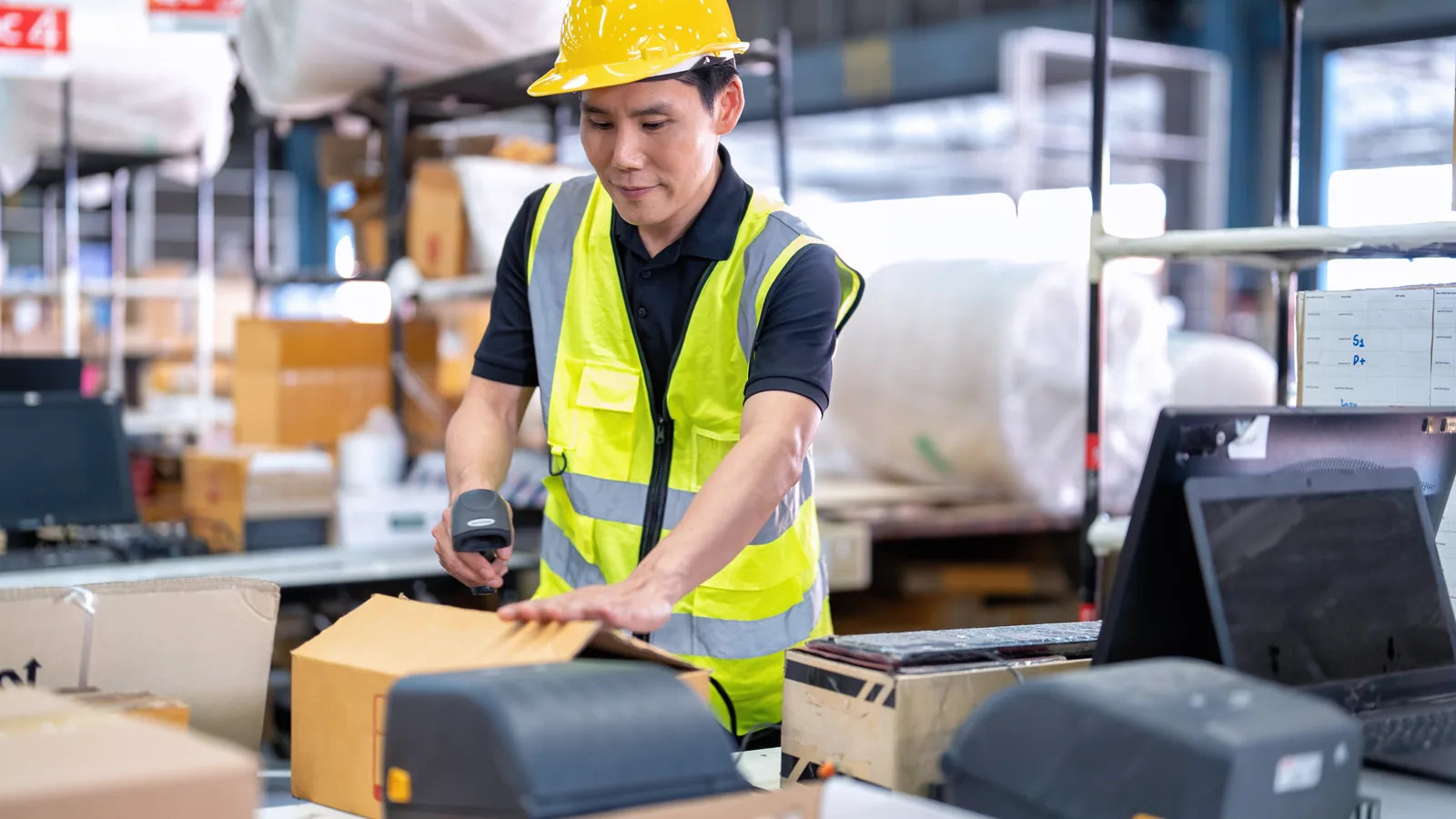 Warehouse operator scanning a package barcode