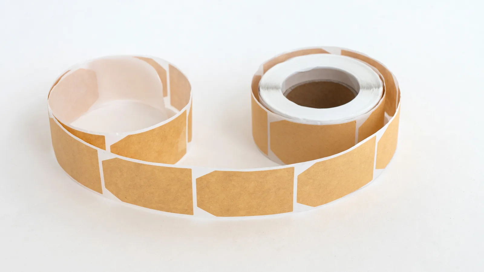 Rolls of blank kraft paper labels ready for printing