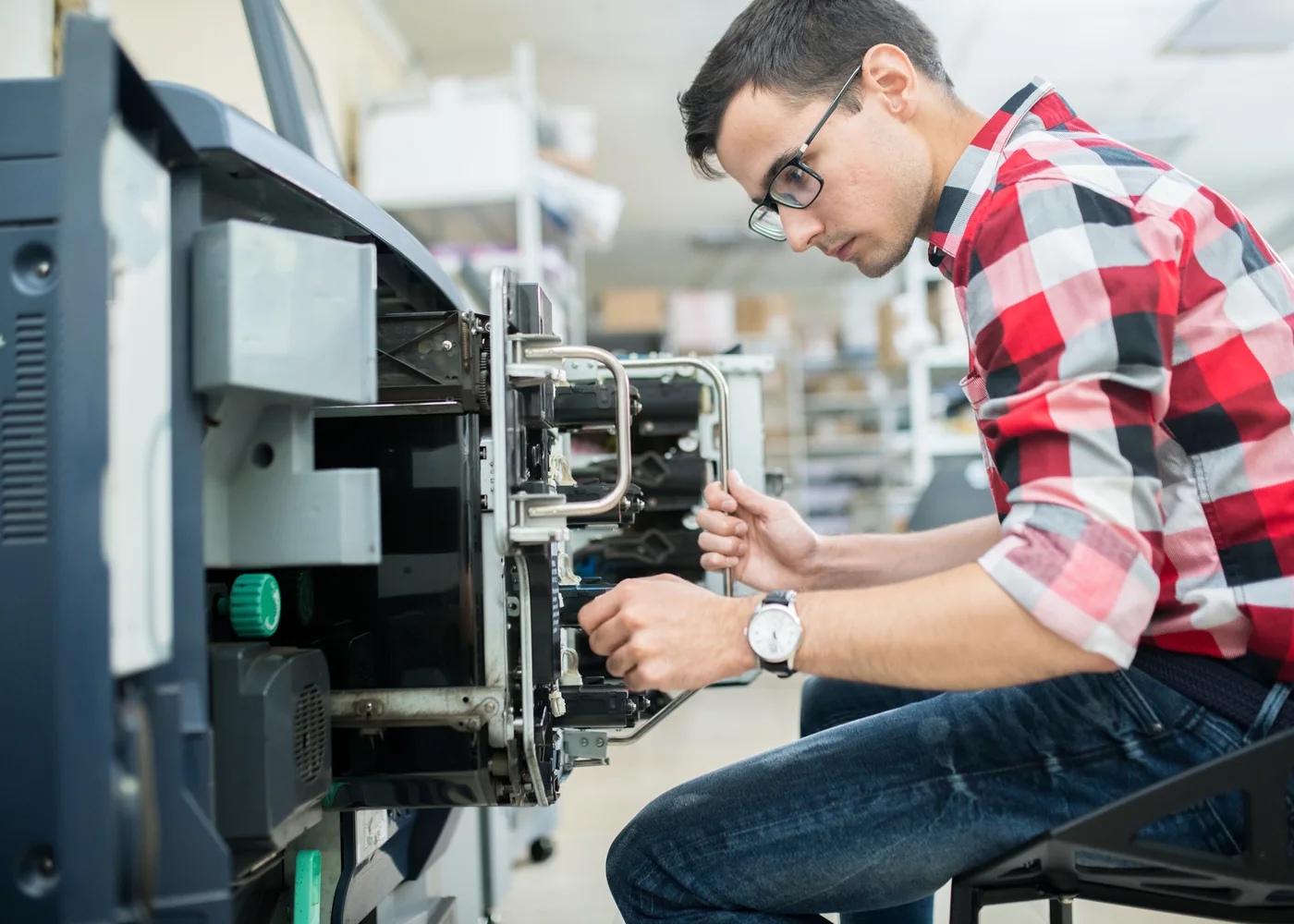 Technician servicing a commercial printer