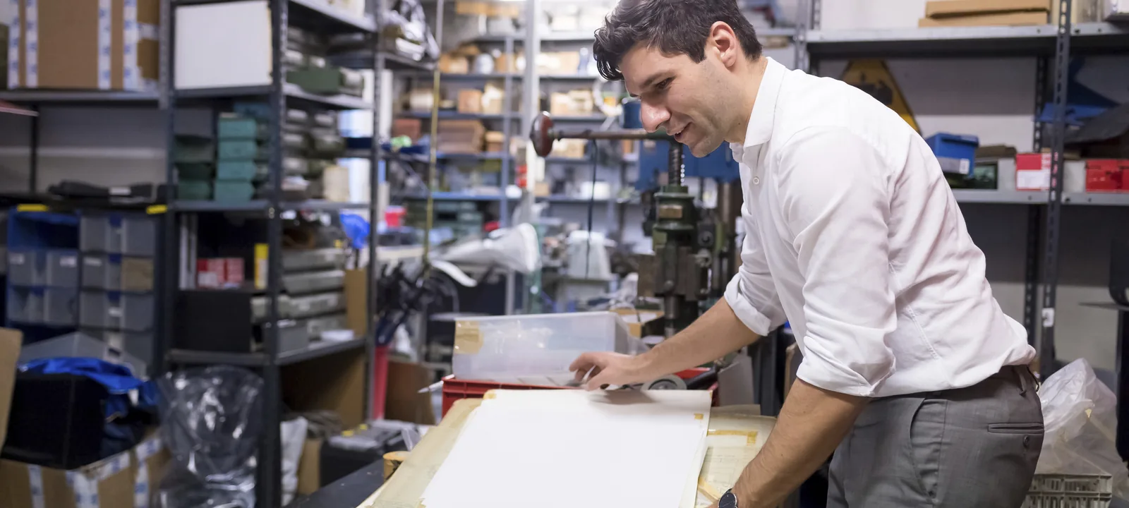 Print specialist reviewing production requirements in a workshop